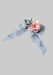 Mayoral light blue-gray velvet ribbon hair bow embellished with two fabric flowers, one in dusty blue-gray and one in soft pink.