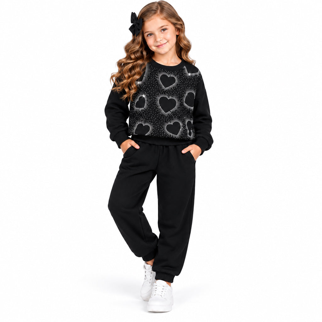 Girls black two-piece set in soft cotton blend. Features hearts sequin detail on the front and coordinating bottoms. 