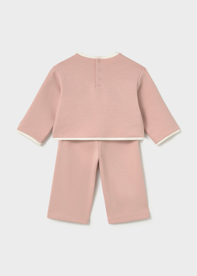 Mayoral A two-piece baby set in dusty pink, featuring a long-sleeve top with white ribbed trim and a teddy bear applique with hearts on the chest, paired with matching cropped pants.