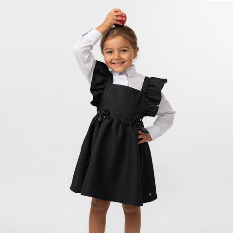 Black flared pinafore with bow from Caramelo Kids.