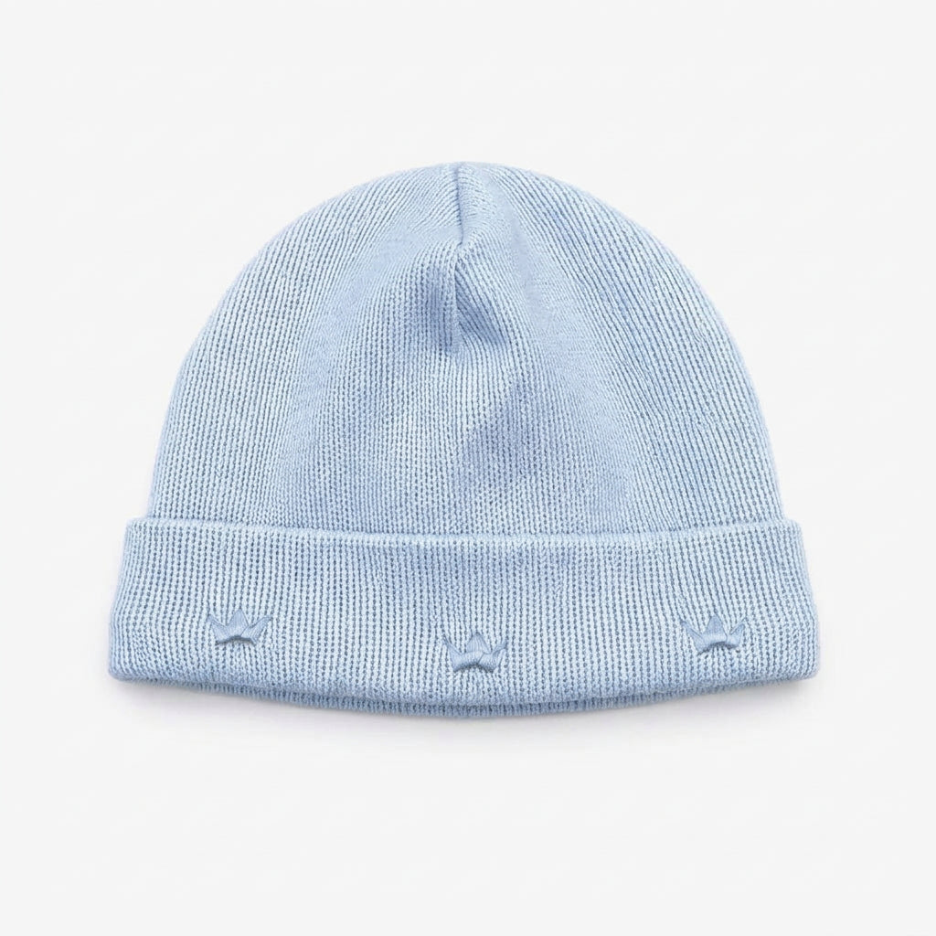 Handcrafted beanie hat in Peru with charming embroidered crowns motif in blue and gold. A special gift for a new baby boy from the Adriana Mae Celeste Reale Collection. Pima Cotton