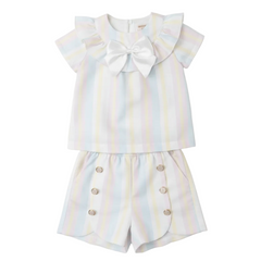Caramelo Kids Rainbow-striped short set, perfect for summer outings. The charming ruffled collar is enhanced with a satin bow. A comfortable elasticated waistband ensures a secure and comfortable fit. 