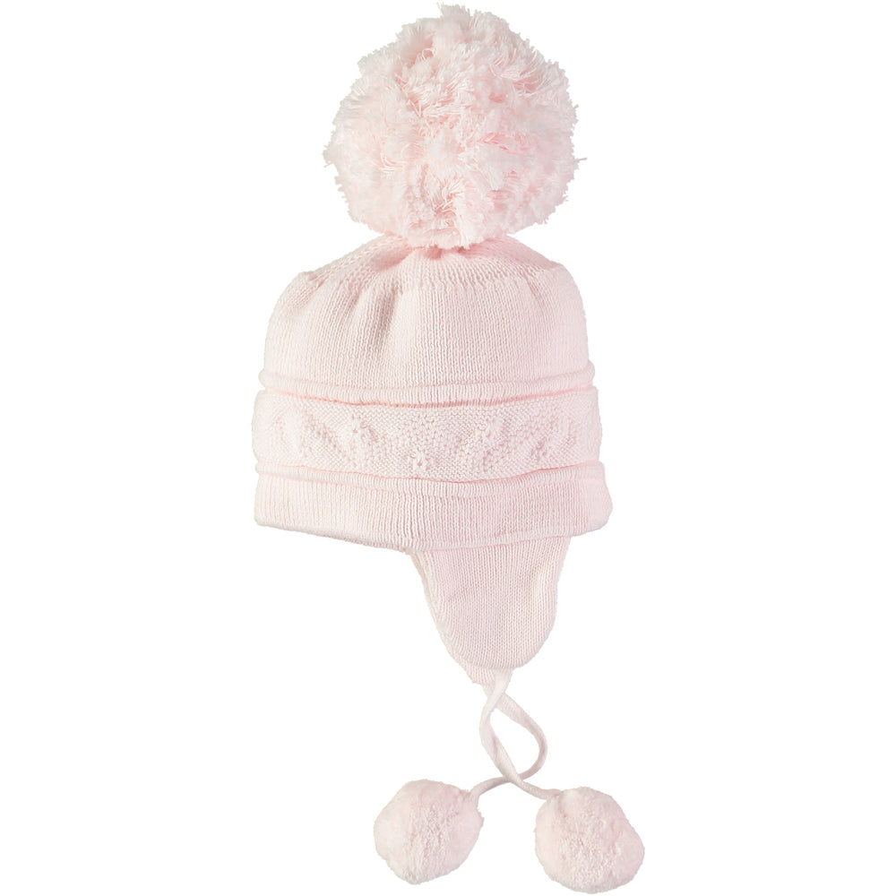EMILE et ROSE Griffin - Baby pink knitted helmet-shaped hat with ear flaps and small pompoms trimming the ends of the ties below each ear. The main feature is the fun, over-size pompom on the top!