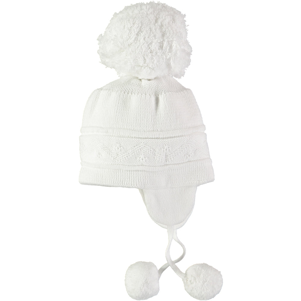 EMILE et ROSE Griffin - Baby white knitted helmet-shaped hat with ear flaps and small pompoms trimming the ends of the ties below each ear. The main feature is the fun, over-size pompom on the top!