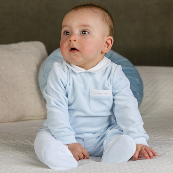 EMILE et ROSE Mason is another velour option for little boys but this time in a two piece. Mainly in soft pale blue velour the co-ordinating white collar and pocket edge are embroidered with blue and stone dashes. The cosy leggings have a gently elasticated waist and white feet with dash embroidery, simple, but smart.