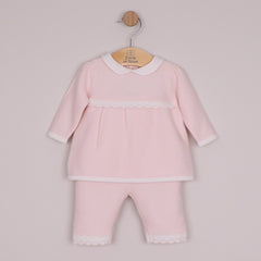 EMILE et ROSE Melanie knitted two-piece has so many beautiful elements making a truly special outfit. Combining a variety of different stitches and white lace scallop crocheted hems, the top is simply stunning. A neat, white, rounded collar and sweet little pearlised buttons add additional detailing to this lovely garment. The knitted trousers also have the same white, crocheted lace effect scallop hems