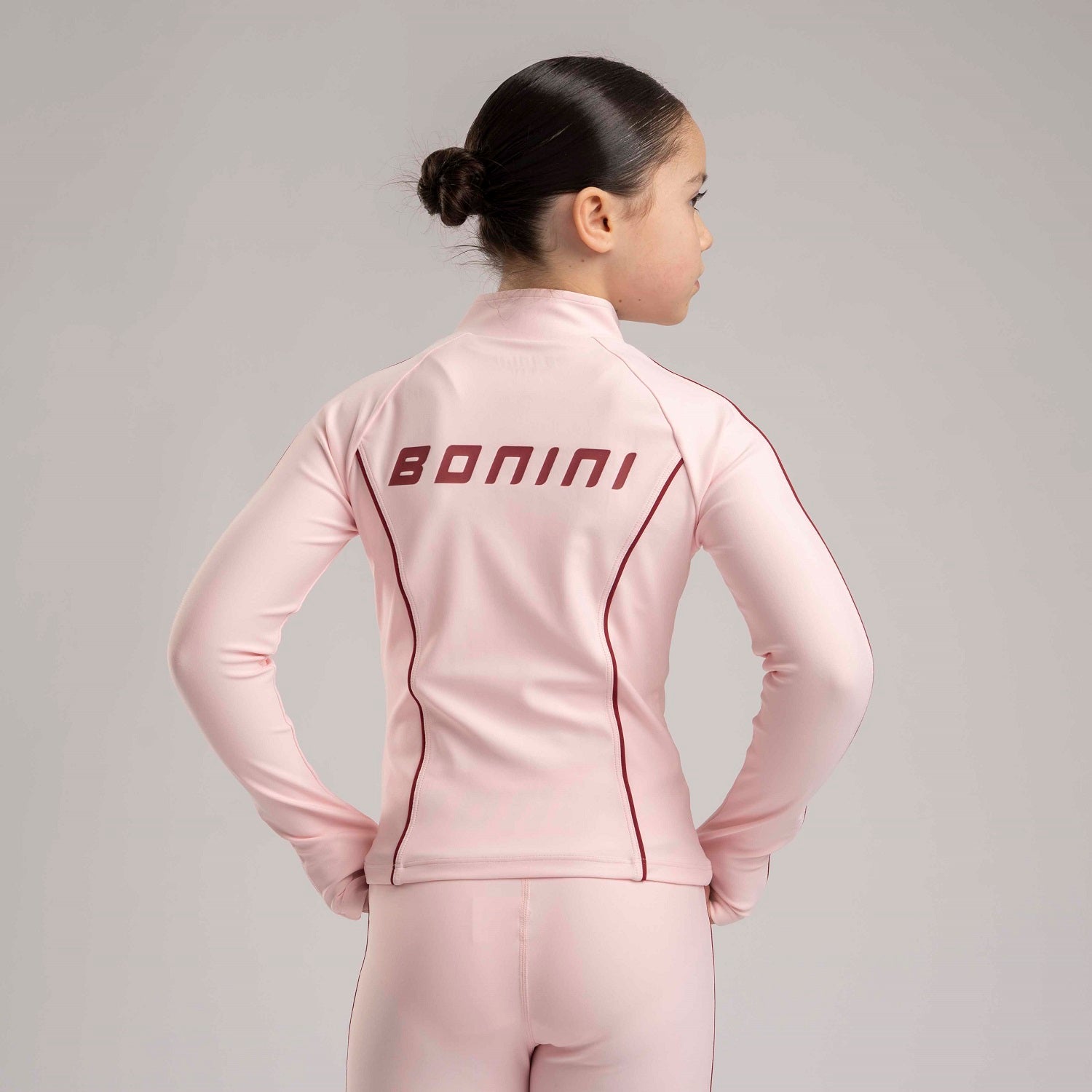 BONINI by ADee The Revive Zipper is designed with a fitted silhouette and clean panel detailing. Finished with signature Bonini branding, it’s ideal for both active days and off-duty styling.&nbsp;Light Pink