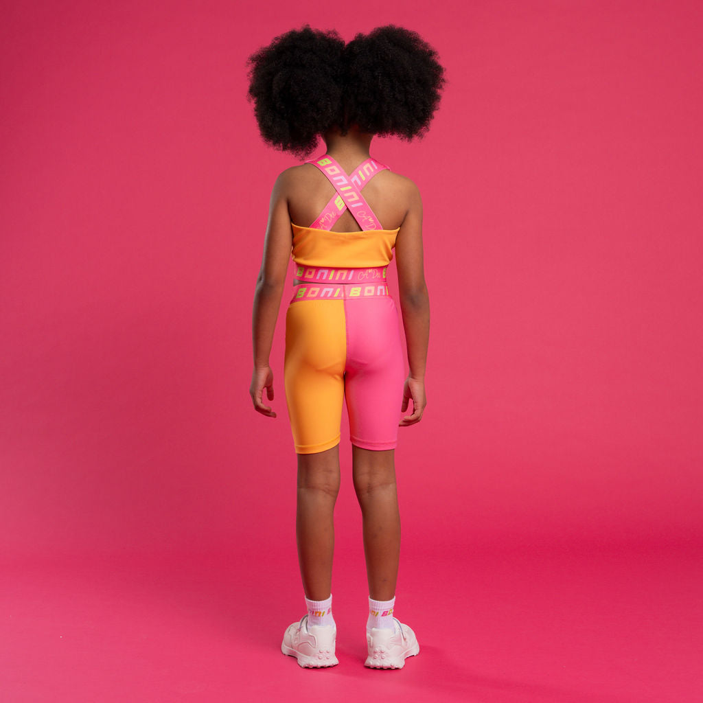 BONINI by ADee The Flex colour block crop top features logo tape cross back straps and is designed to match pieces within the collection. Hot Pink