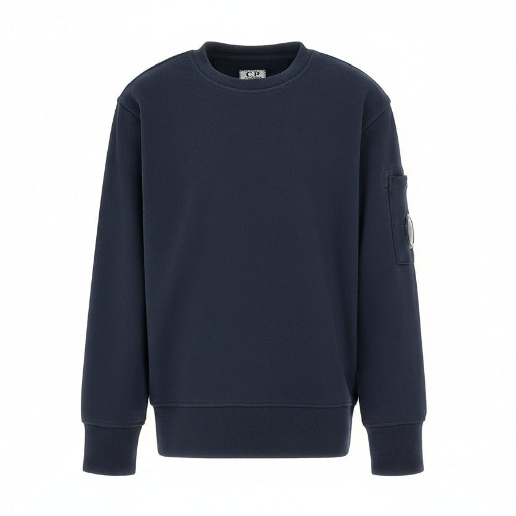 C.P. Company boys' diagonal fleece crewneck sweatshirt with iconic lens detail, digital ribbed texture, and reinforced cuffs and hem. Regular fit for everyday versatility. Total Eclipse Blue