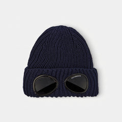 C.P. Company Kids Iconic goggle detail integrated into the turn-up brim. Dense ribbed wool creates structure and superior insulation. Adjustable turn-up brim for extra warmth. Premium construction built for daily winter wear. 100% Wool Hand wash. Navy