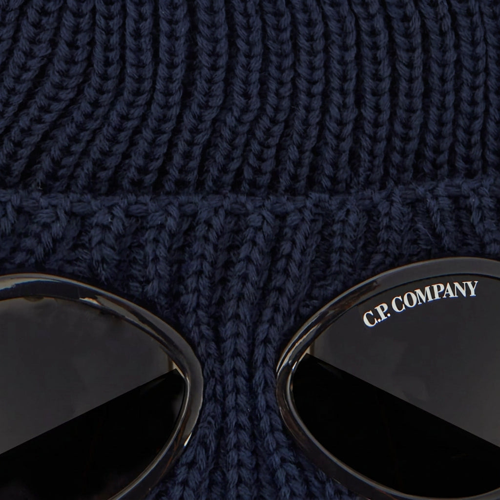 C.P. Company Kids Iconic goggle detail integrated into the turn-up brim. Dense ribbed wool creates structure and superior insulation. Adjustable turn-up brim for extra warmth. Premium construction built for daily winter wear. 100% Wool Hand wash. Navy
