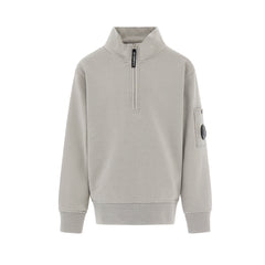 C.P. Company boys' U16 diagonal fleece half zip closure, high neck sweatshirt with iconic lens detail, ribbed texture, and reinforced cuffs and hem. Regular fit for everyday versatility. Smoke Grey