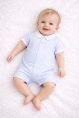 The Hudson romper from Pastels &amp; Co. Crafted in a serene pale blue, this piece combines understated elegance with practical comfort.