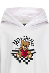 Optical white sweatshirt with hood for girls by the luxury Italian designer Moschino. Made from soft cotton, features the brands iconic Teddy Bear with red heart logo print on the front.