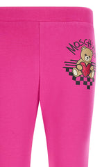 Fuchsia leggings for girls by the luxury Italian designer Moschino. Crafted from soft cotton with a touch of elastane, it showcase the brand's iconic Teddy Bear motif with red heart logo print on the front. The elasticated waistband deliver both comfort and contemporary style.