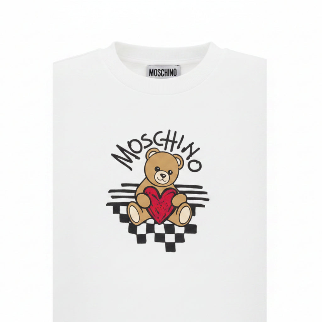 Optical White T-shirt girls by the luxury Italian designer Moschino. Made from soft cotton jersey, it features the bears brand's logo with heart print on the front.