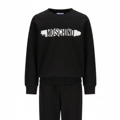 Moschino Kids Tracksuit in black, featuring logo print in white and black on the front of sweatshirt and also on the jogger trousers. Elasticated waistband and ribbed trims for comfort. Suitable for boys and girls.