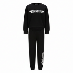 Moschino Kids Tracksuit in black, featuring logo print in white and black on the front of sweatshirt and also on the jogger trousers. Elasticated waistband and ribbed trims for comfort. Suitable for boys and girls.