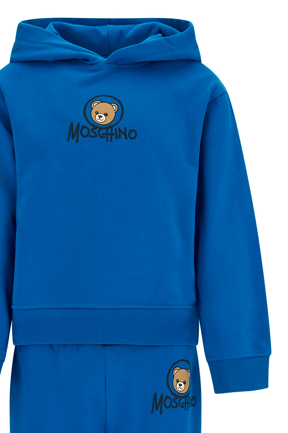 Moschino Kids Hooded Tracksuit in princess blue, featuring the iconic teddy bear and logo print. Soft cotton construction with ribbed trims, elasticated waistband and ankles on jogger trousers. Suitable for boys and girls.