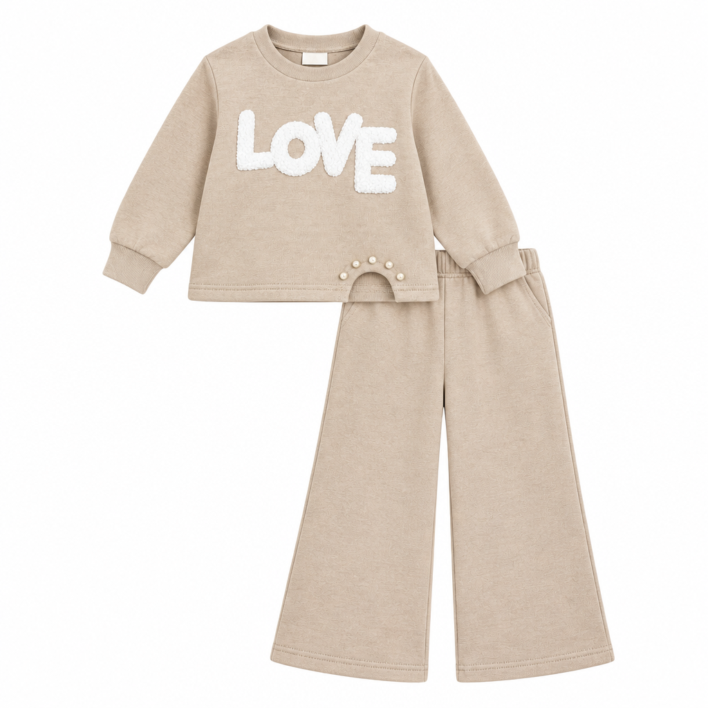 Girls beige knitted two-piece set with LOVE appliqué and pearl detail. Wide-leg bottoms create a relaxed, modern silhouette. Soft coordinating pieces perfect for everyday wear or special occasions.