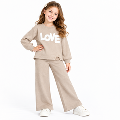 Girls beige knitted two-piece set with LOVE appliqué and pearl detail. Wide-leg bottoms create a relaxed, modern silhouette. Soft coordinating pieces perfect for everyday wear or special occasions.