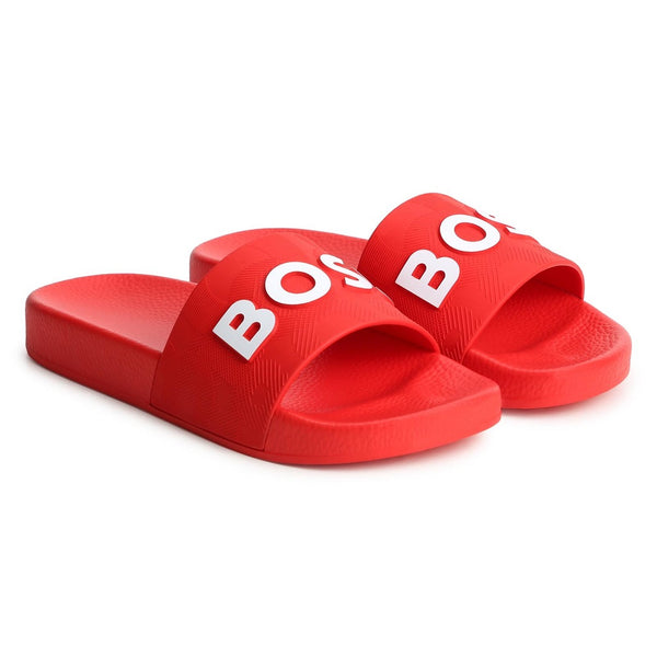 BOSS KIDS Slides in PVC with branding relief effect. They are made in light materials for optimal comfort. SOLD WITH ONE HANGER.