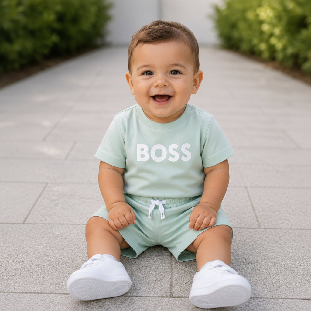 BOSS Baby Boys Short-sleeved T-shirt in 100% cotton jersey, snap closure at the shoulder, "BOSS" print on the front. Paired with BOSS Baby Boys swim short