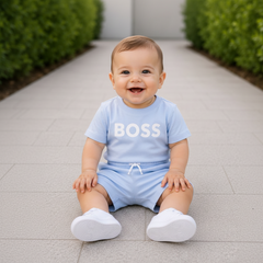BOSS Baby Boys Short-sleeved T-shirt in 100% cotton jersey, snap closure at the shoulder, "BOSS" print on the front. Paired with BOSS Baby Boys Permanent surfer shorts
