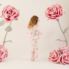 LITTLE A The Dakota tracksuit features an all-over rose print, a cosy long sleeve sweatshirt, and matching leggings. Finished with soft ribbed trims for a comfy and coordinated look.