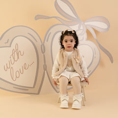LITTLE A by ADee Little Locket Theme. The Dani gilet features ultra-soft faux fur, a cosy sleeveless design, and a sweet bow detail at the front. Stone Beige