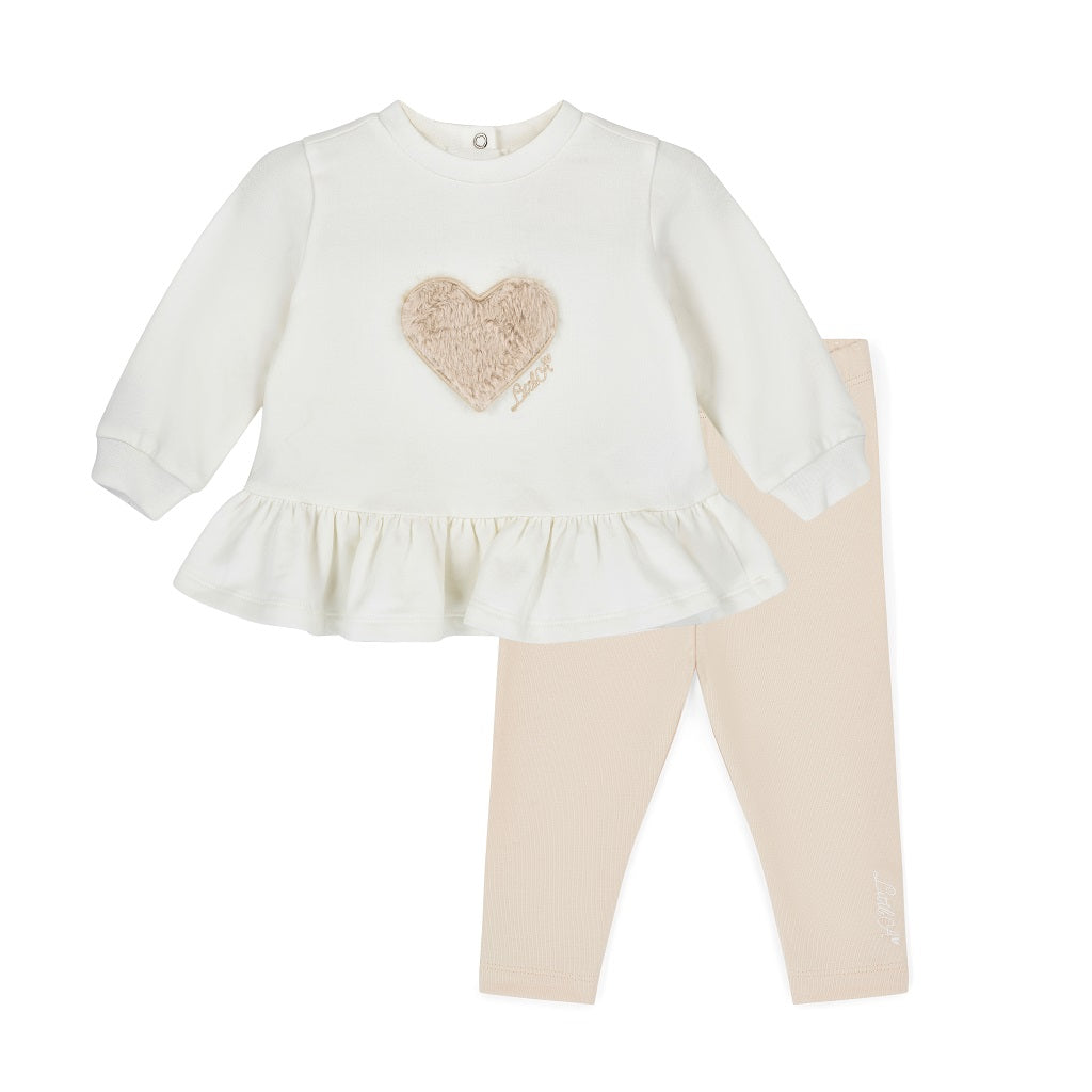 LITTLE A by ADee Little Locket theme. The Demi legging set features a long sleeve jumper top with a sweet heart detail and peplum frill hem, paired with soft leggings finished with a subtle motif. A comfy and cute everyday outfit. Snow White/Stone Beige