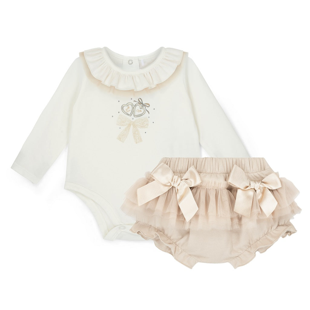 LITTLE A by ADee Little Locket theme. The Emylee jam pant set features a soft long sleeve bodysuit with a delicate heart locket print and frill neckline. Paired with matching tulle frill bloomers, finished with sweet bow details for an extra pretty touch. Snow White/Stone Beige