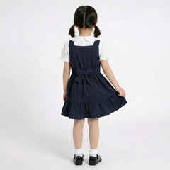 LELLI KELLY Becky Navy School Pinafore featuring a charming bow detail on the back and charm with LELLI KELLY logo on the front