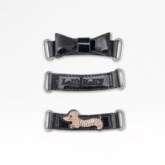 LELLI KELLY Taylor shoes in classic black patent leather, featuring charming diamante dog straps that add a playful touch. The interchangeable straps