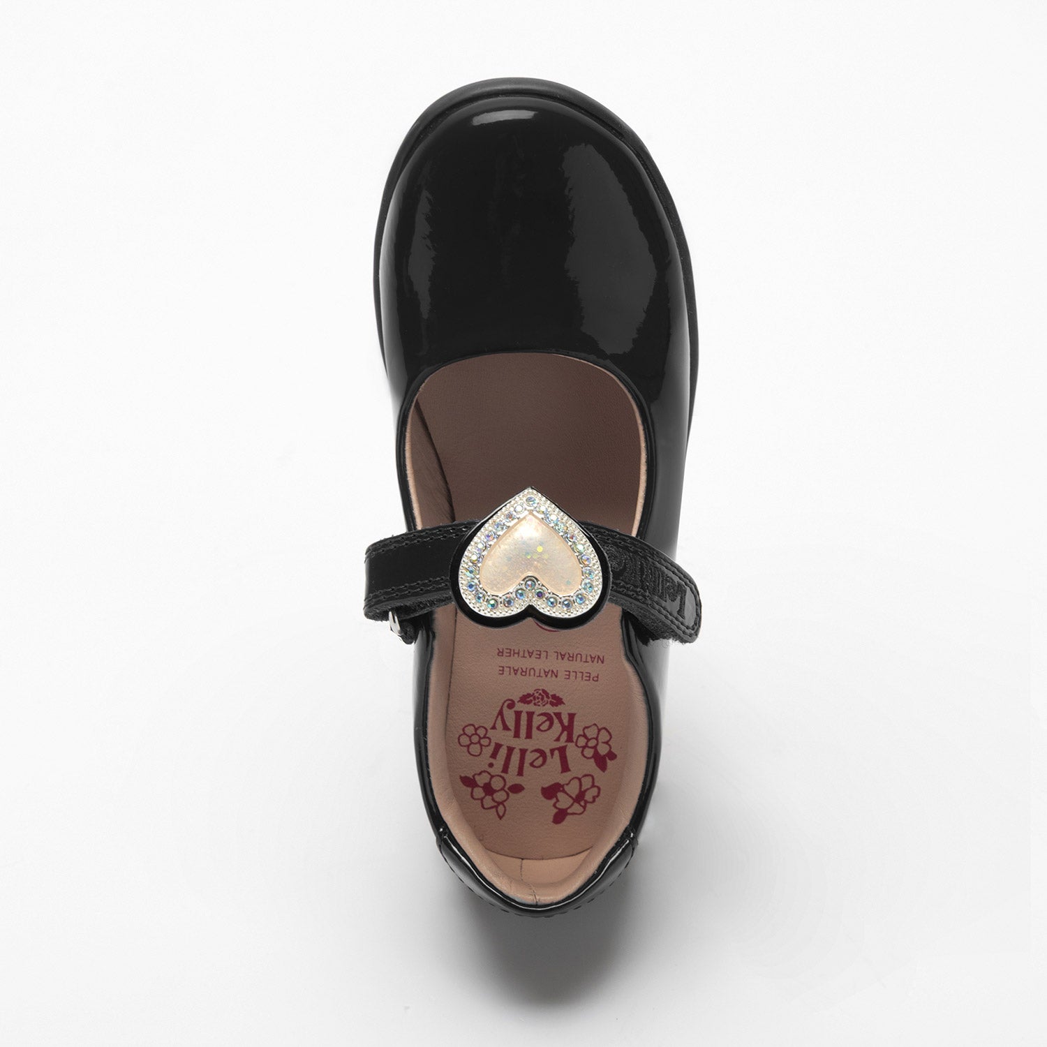 Lelli Kelly Sabrina comes in a black patent upper. Sabrina has a hook and loop fastening. A large cream diamante framed heart that changes colour in the sunlight sits on the strap fastening and this can be slid off and replaced with a bow. Pink Leather lining completes the look