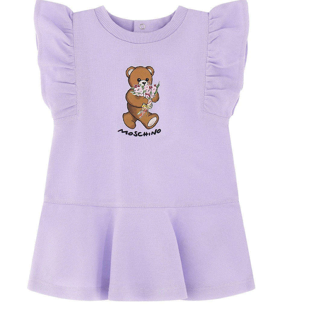 A MOSCHINO baby girls dress in pastel lilac cotton piqué, adorned with the brand's signature teddy bear print and rubberized logo