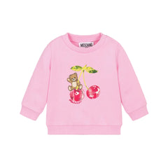 Pink cotton jersey sweatshirt by Moschino for baby girls, featuring a teddy bear and cherry motif with ribbed trims and shoulder poppers.