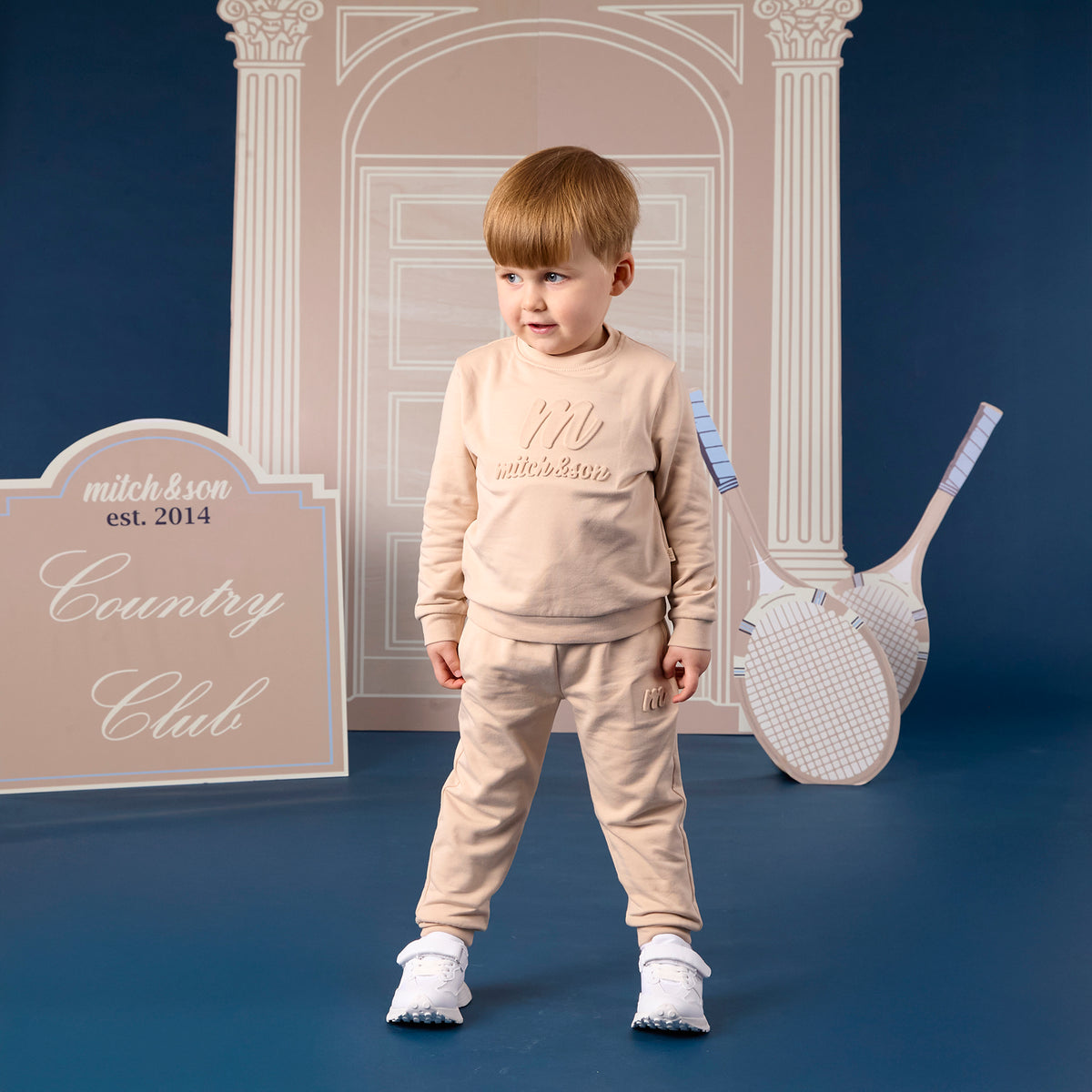 MITCH &SON Classic Collection. The Seth tracksuit features a sweatshirt with subtle embossed logo detailing and matching joggers. Designed with ribbed trims for a comfortable, easy fit. Stone Beige