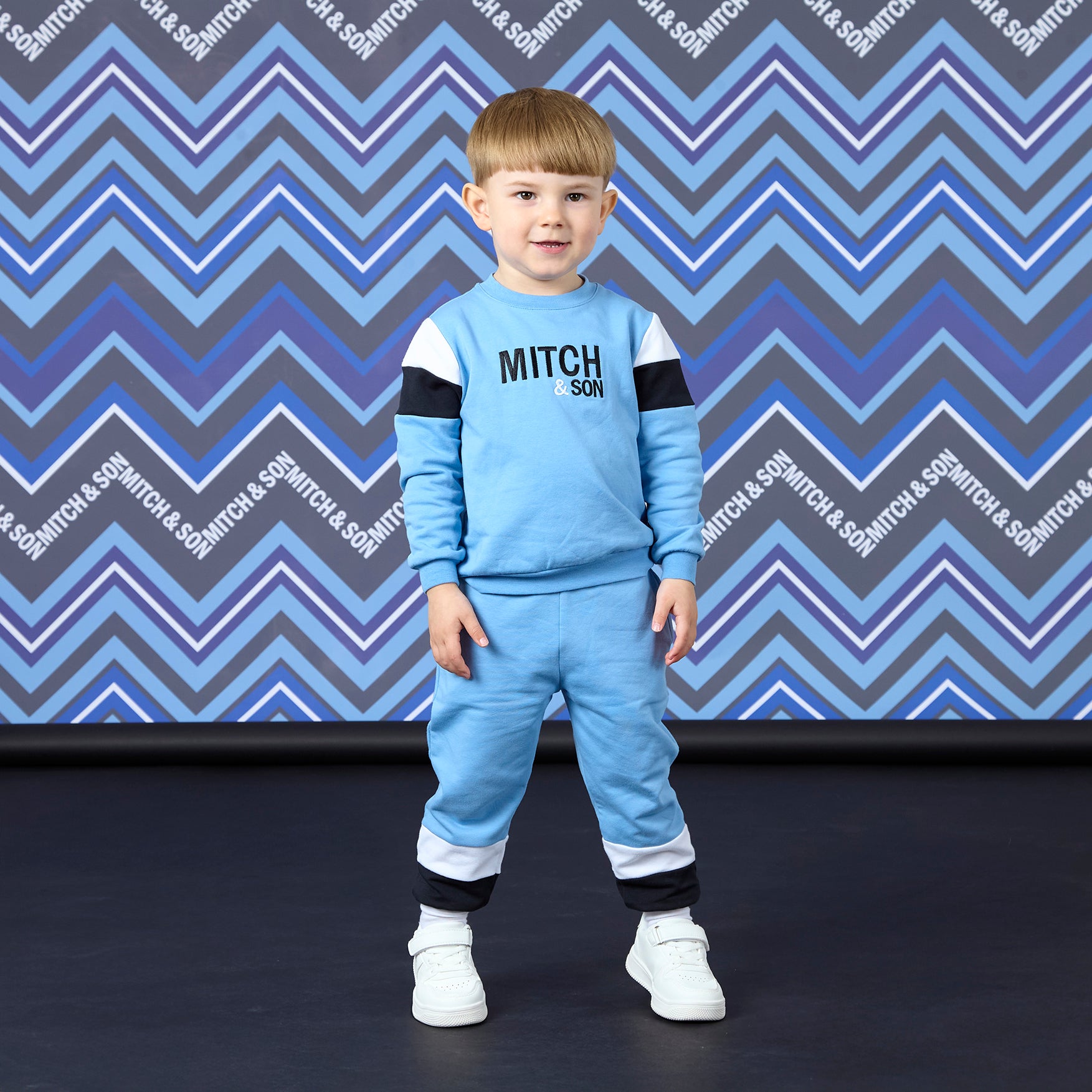 MITCH & SON Winter Chevron. The William tracksuit features a classic crewneck sweatshirt with bold front branding and matching joggers. Designed for everyday comfort with a clean, sporty feel. Cornflower Blue
