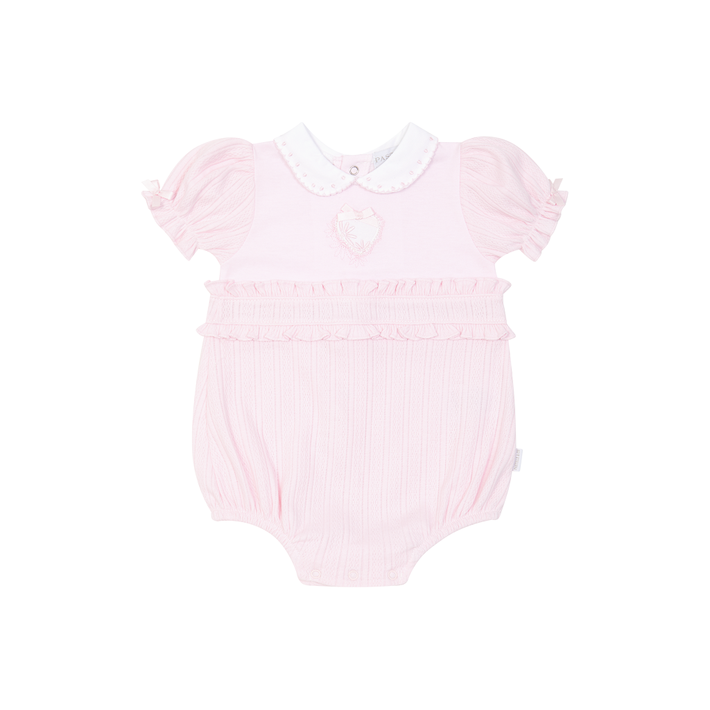 Pastels &amp; Co Hattie romper in soft pale pink with an adorable love heart design. Perfect for little ones who love sweet, charming styles.