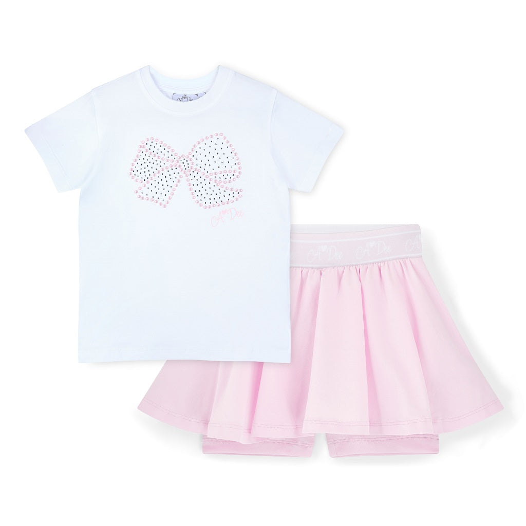ADEE Boutique Chic - The Rose skort set is pretty and practical, featuring a pleated skort with a branded waistband and paired with a white top with a pearl bow design.