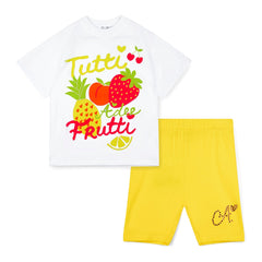ADEE Trinity short set features an oversized Tutti Frutti print t-shirt, paired with yellow cycling shorts finished with diamante logo on one leg.