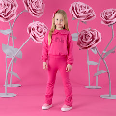 ADEE Winter Bloom Collection. The Amara Set features a sweatshirt with a beautiful bow collar and sparkling A*Dee diamante branding, paired with matching flares finished with a classic diamante “A” on one leg. Fuchsia
