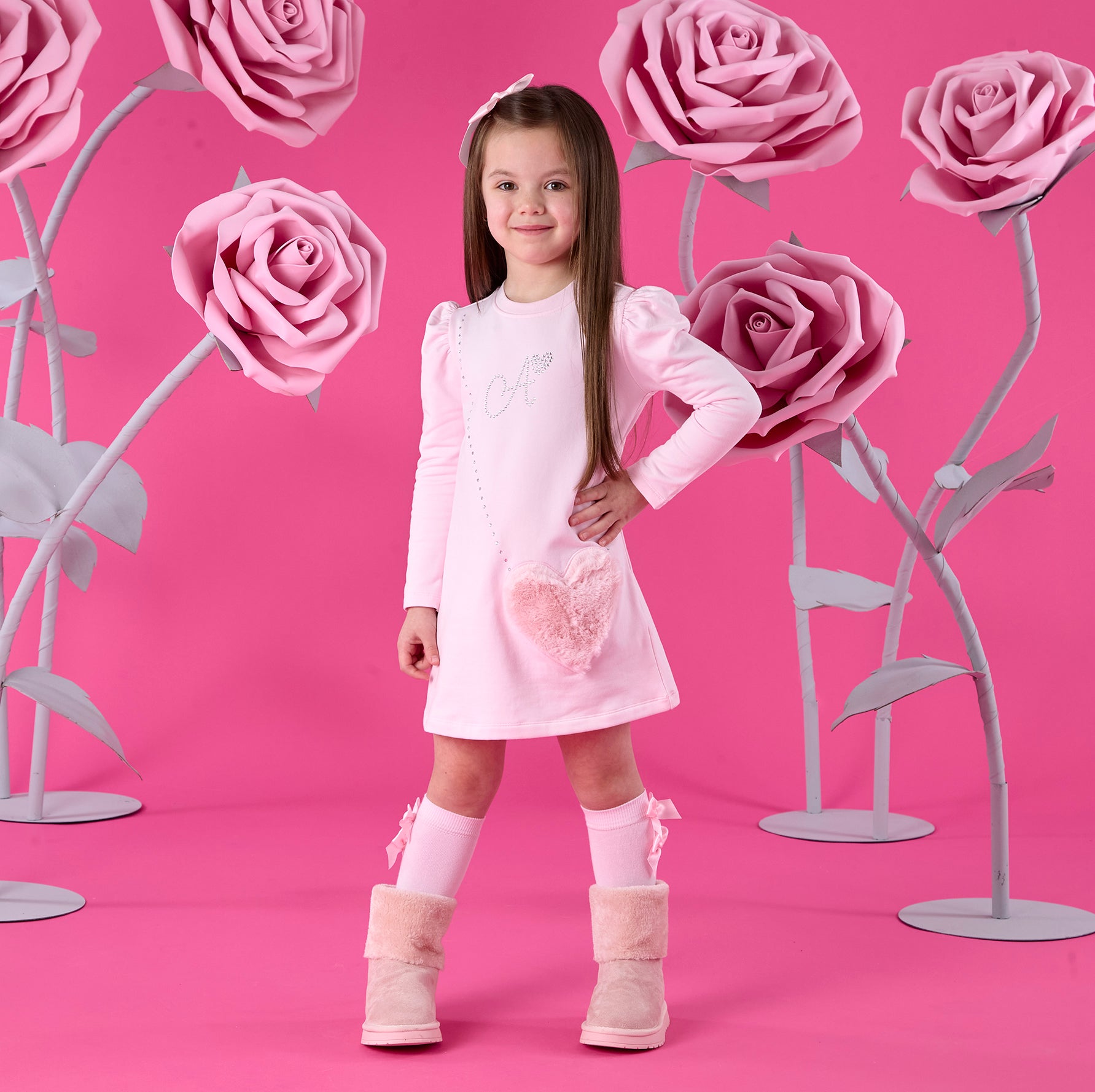 ADEE Winter Bloom Collection. The Alyssa dress features a faux fur applique handbag artwork, finished with a classic A*Dee diamantélogo. Pale Pink