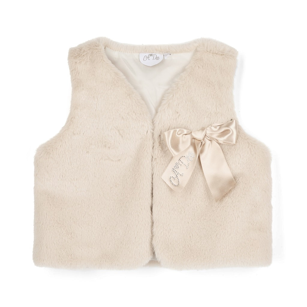 ADEE Eau-de Adee Collection. The Anna gilet come in fabulous faux fur and is finished with a beautiful appliqué bow on the chest. Stone Beige