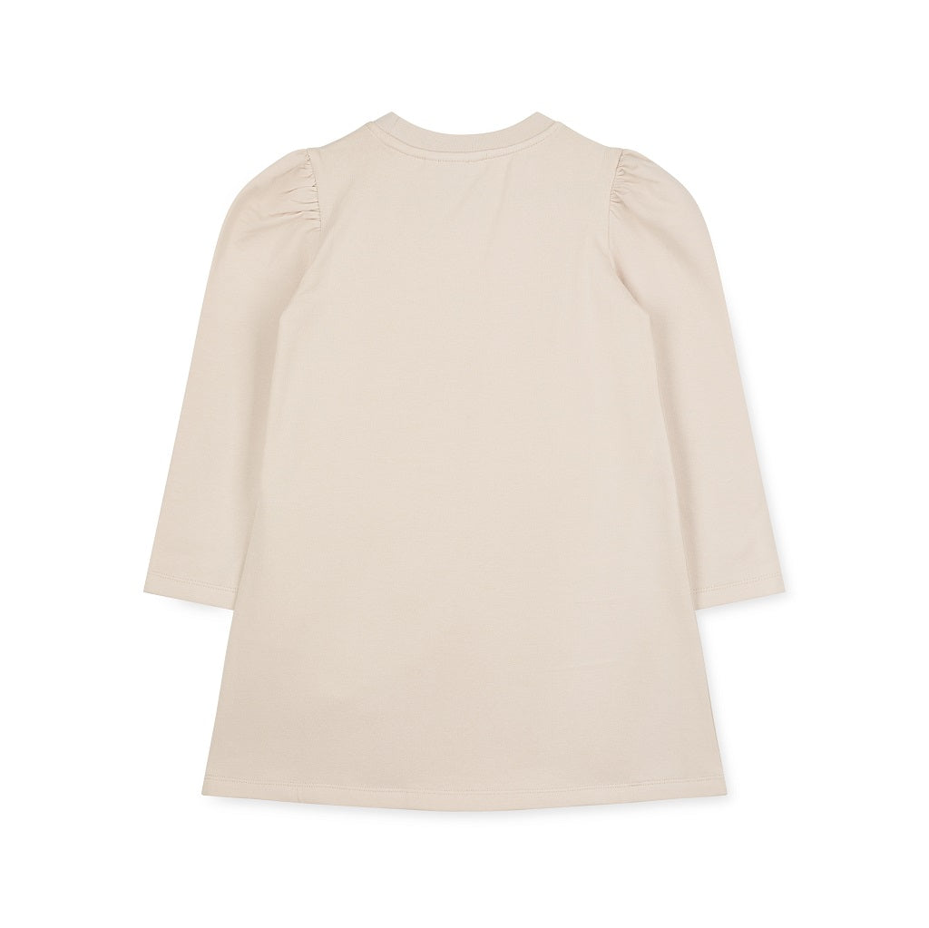 ADEE Eau de theme. The Alyssa dress features a faux fur applique handbag artwork, finished with a classic A*Dee diamanté logo. Stone Beige
