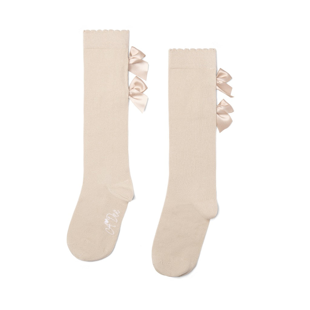 ADEE Eau de Adee Collection. A cute finishing touch, the Ariel knee-high socks are detailed with two sweet appliqué bows at the ankle. Stone Beige