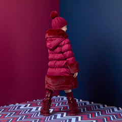 ADEE Chevron Charm theme. Introducing the Aurora Jacket, a beautiful fit-and-flare style, finished with soft faux fur trims at the hood, cuffs, and hem. The cosy fleece lining and hood keep you warm, while signature details include a branded badge, logo zip pull, and sweet bows on each arm. Deep Cherry