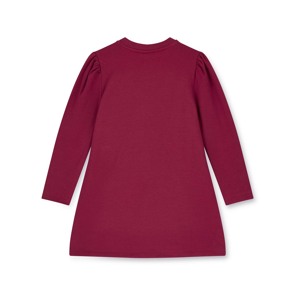 ADEE Chevron Charm Collection. The Alyssa dress features a faux fur applique handbag artwork, finished with a classic A*Dee diamanté logo. Deep Cherry