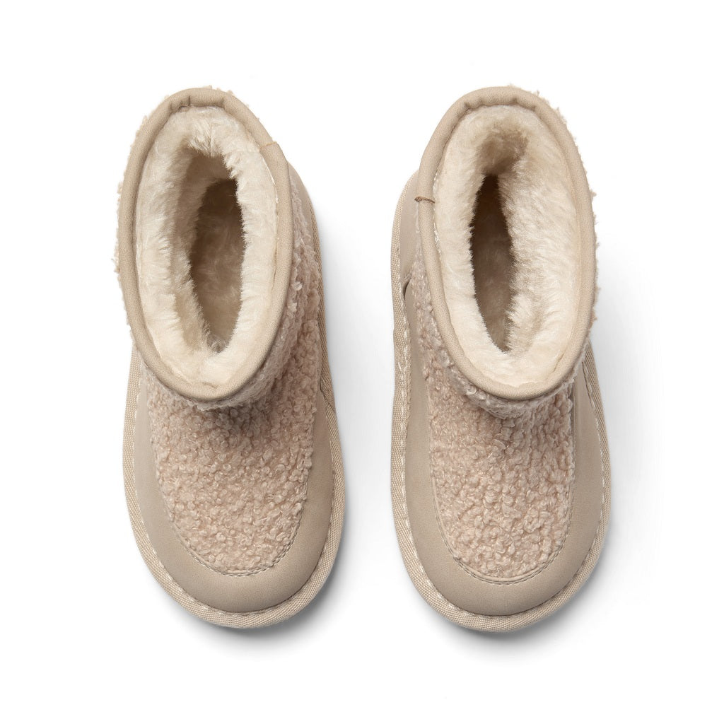 ADEE A cosy update to everyday footwear, the Teddie boots are crafted from soft faux suede and finished with a chunky sole and signature logo detail. Stone Beige